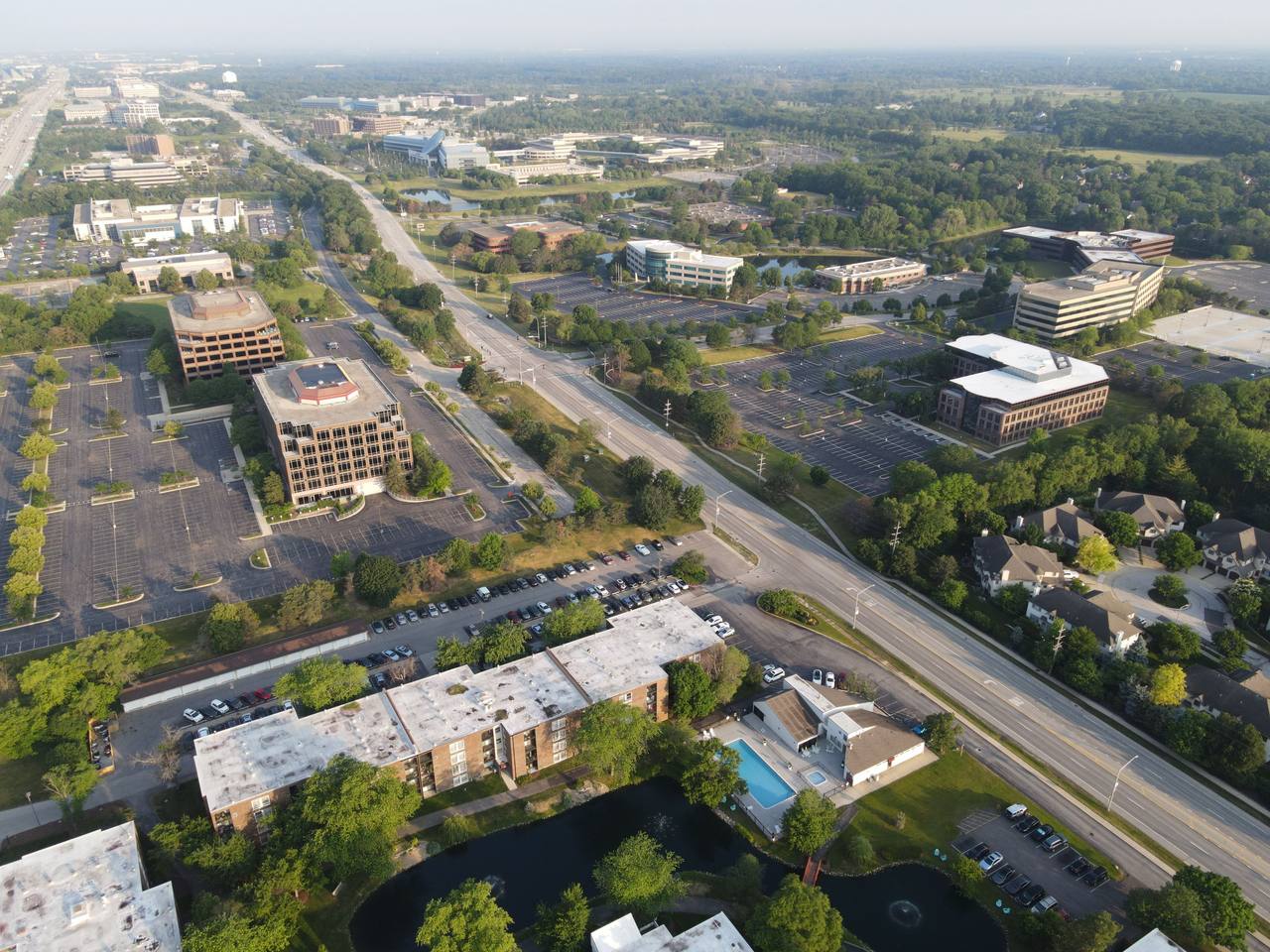 Aerial view of a suburban business district with office buildings and large surface parking lots